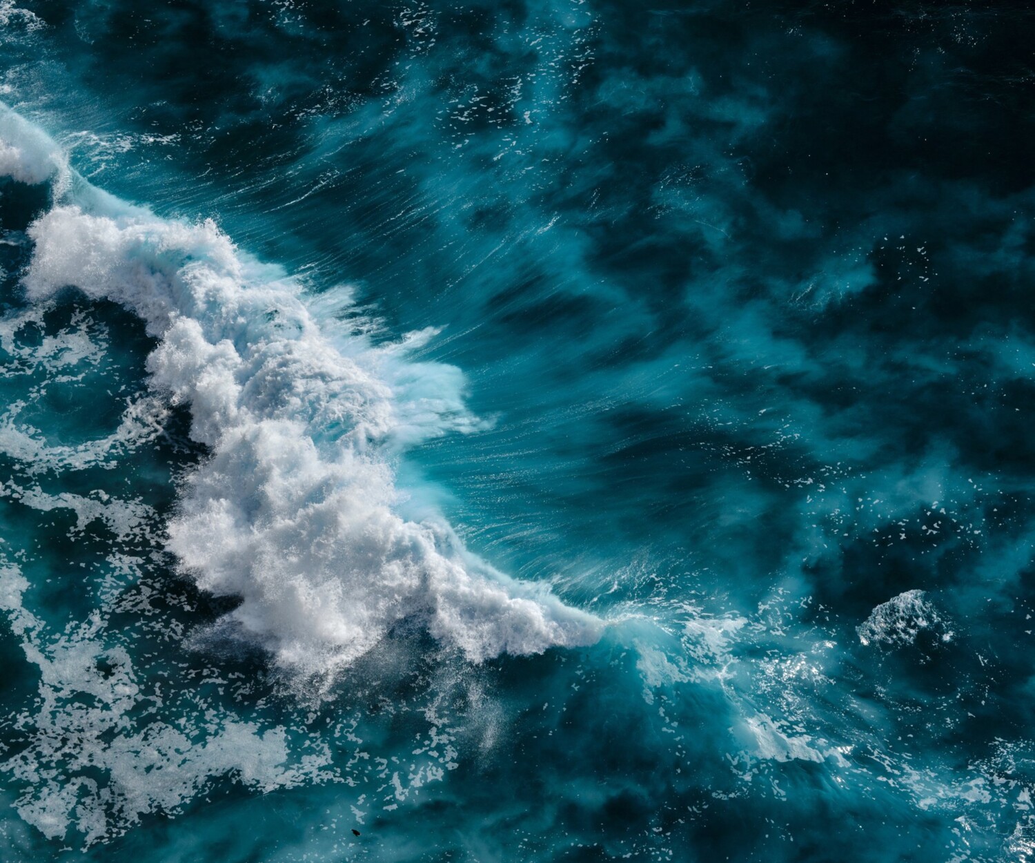Aerial view to waves in ocean Splashing Waves. Blue clean wavy sea water. Bali, Indonesia.